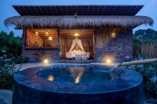 a hot tub in front of a hut at Shigar Livin Bali in Sidemen
