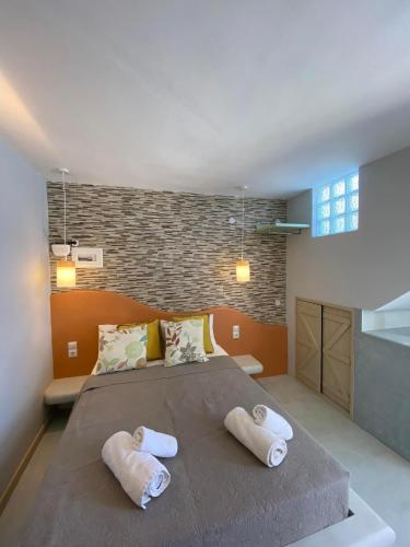 a bedroom with a large bed with towels on it at MOUSELIS APARTMENTS in Kalymnos