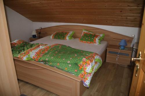 a bedroom with two beds with colorful blankets and pillows at Ferienwohnungen Anna Geißinger in Mauth