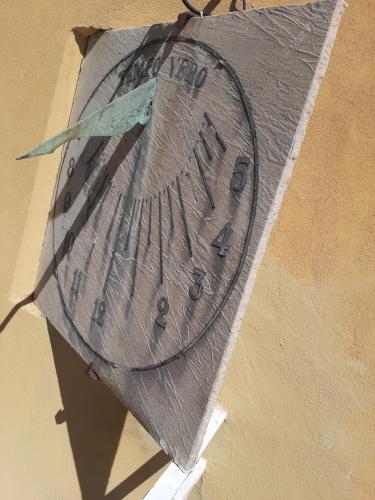 a painting of a clock on the side of a wall at Sorrento Tower in Sorrento