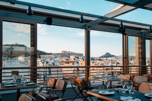 a dining room with a large window overlooking a city at Ilissos in Athens