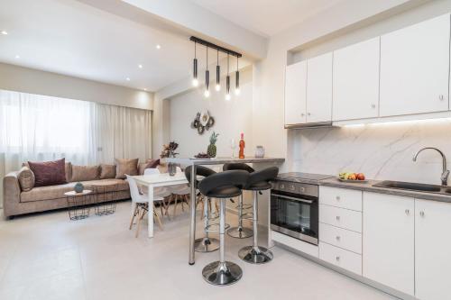 a kitchen and living room with a table and a couch at Selozia Apartment in Zakynthos Town