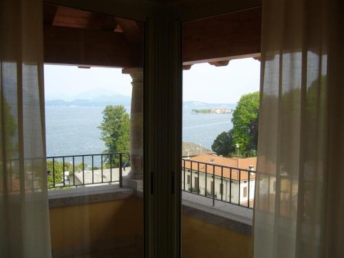 a view of the water from a balcony at Hotel Azalea in Baveno