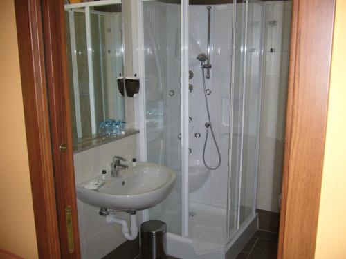 a bathroom with a shower and a sink at Hotel Azalea in Baveno