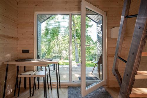 a room with a table and a large window at Rest Green in Degesiai