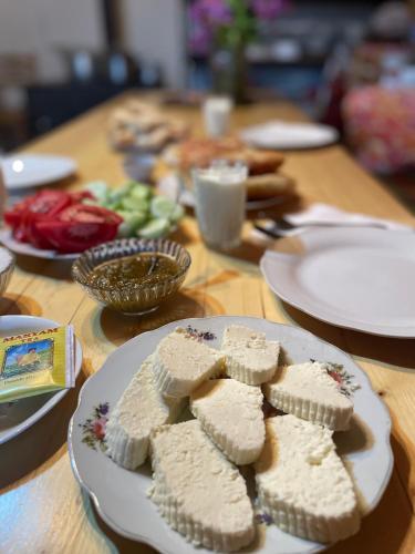a table with white plates of food on it at Gunter Guest house in Adishi