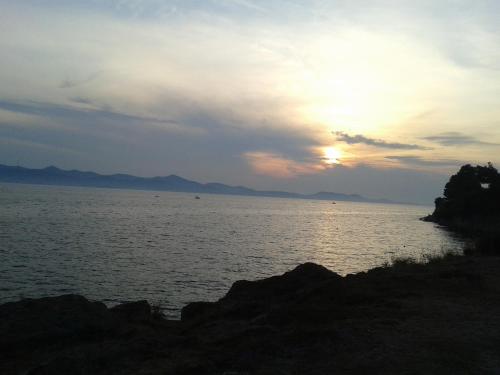 a sunset over a large body of water at Studio Antonio New in Zadar