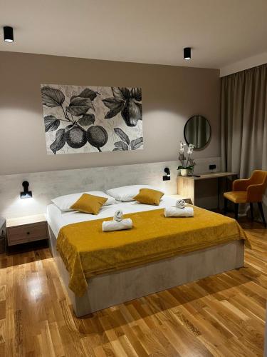 a bedroom with a large bed with towels on it at MEMORI bed&breakfast in Rab