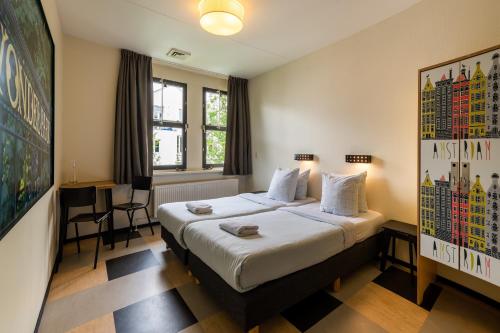 a hotel room with a bed and a table at Stayokay Hostel Amsterdam Vondelpark in Amsterdam