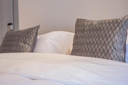 a bed with two pillows on top of it at The Arran, St Andrews in St. Andrews