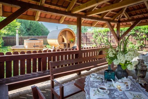 a patio with a table and a gazebo at Apartamenty Galeria Trunków in Białowieża