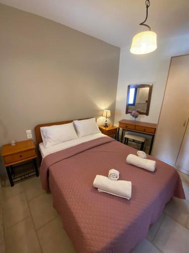a bedroom with a bed with two towels on it at MOUSELIS APARTMENTS in Kalymnos
