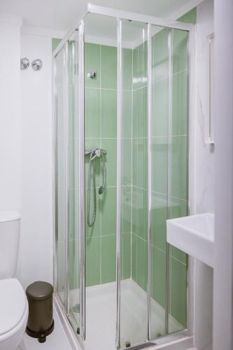 a glass shower in a bathroom with a toilet at The Lx Hill in Lisbon
