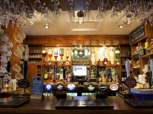a bar with a lot of bottles of alcohol at The Endeavour in Whitby