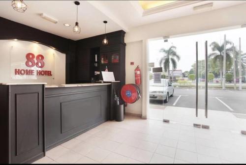 a store front with a home korea sign on the window at Hotel Home 88 in Teluk Intan