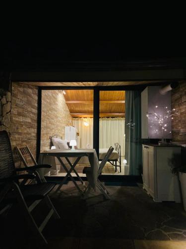 a table and chairs in a living room at night at B&B Il Sentiero in San Sperate