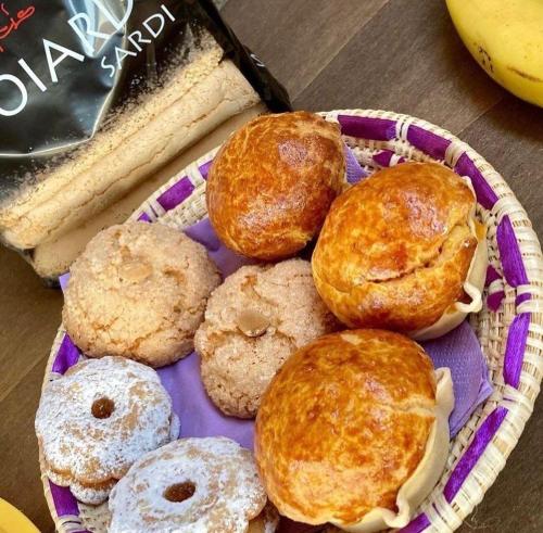 a basket of different types of pastries on a table at B&B Il Sentiero in San Sperate