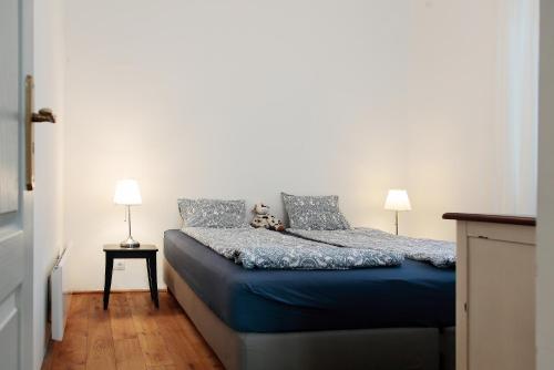 a bedroom with a bed with a teddy bear on it at Angel holiday appartman in Szentantalfa