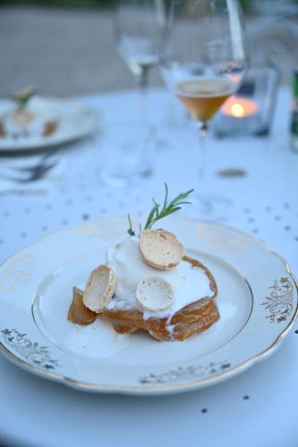 a white plate with food on a table at Le Petit Château in Baye