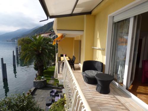 a balcony of a house with a view of the water at Casa Conti al Lago in Ronco s/Ascona - Porto Ronco