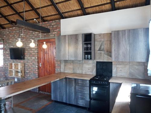 a kitchen with a wooden counter top and a stove at Studios @ Delver in Parys