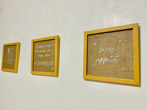 three framed pictures on a wall with writing on it at SCANDINAVIAN THEMED-1BR CONDO-Marilao Bulacan-TheRichPlacePH 7 in Marilao