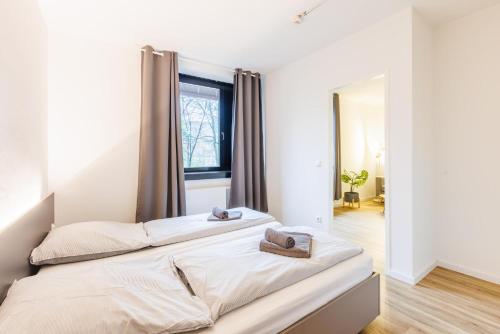 a bedroom with a bed with two towels on it at Glück Auf Appartements Düppelstraße in Oberhausen