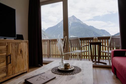 a living room with a view of a mountain at Apart Peak Ötztal in Längenfeld