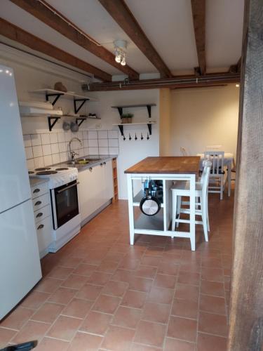 a kitchen with a table and chairs in a room at Älgbergets Bed & Breakfast in Ucklum