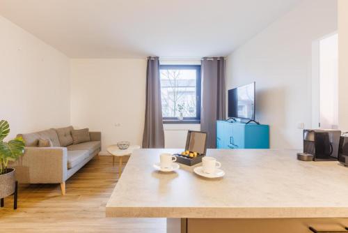a living room with a table with two cups on it at Glück Auf Appartements Düppelstraße in Oberhausen