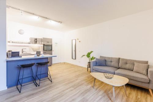 a living room with a couch and a table at Glück Auf Appartements Düppelstraße in Oberhausen