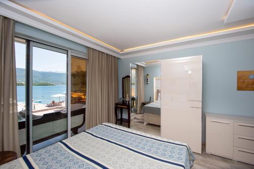 a bedroom with a bed and a view of the ocean at Aquamarine House in Tivat