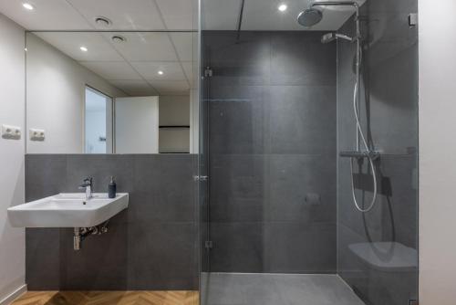 a bathroom with a sink and a shower at Glück Auf Appartements Düppelstraße in Oberhausen