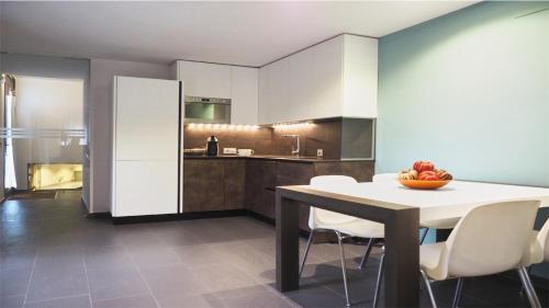 a kitchen with a table and chairs in a room at Apartamento rural Castillo de Yeste 2 pax in Yeste