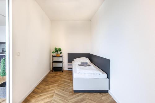 a small room with a bed in the corner at Glück Auf Appartements Düppelstraße in Oberhausen