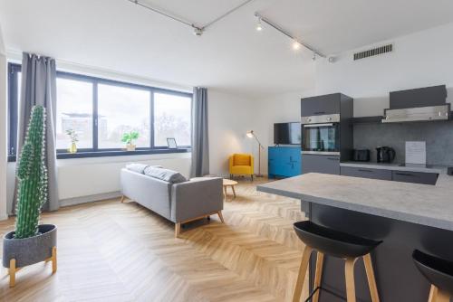 a kitchen and living room with a couch and a table at Glück Auf Appartements Düppelstraße in Oberhausen