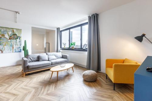 a living room with a couch and a table at Glück Auf Appartements Düppelstraße in Oberhausen