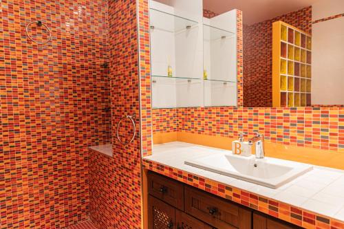 a bathroom with a sink and a tiled wall at Casa Rural CUESTA GRANDE in Mota del Cuervo