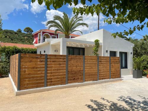 a wooden fence in front of a house at Andromahi Apartments & Suite in Laganas