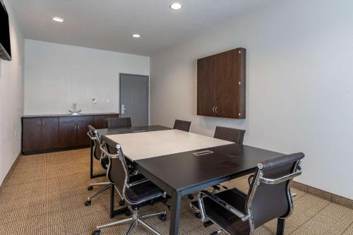 a conference room with a black table and chairs at Comfort Inn & Suites in Aztec