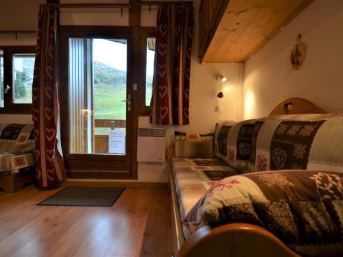 a room with two beds and a window at Studio cabine 4 pers, balcon, animaux autorisés - FR-1-452-279 in Les Menuires