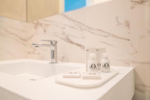 a bathroom sink with two bottles of toothpaste on it at La Suite del Borghetto in Pisa