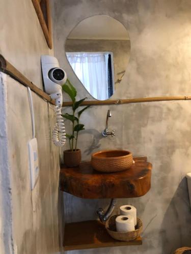 a bathroom with a sink and a mirror at Pousada Pipe House in Itacaré