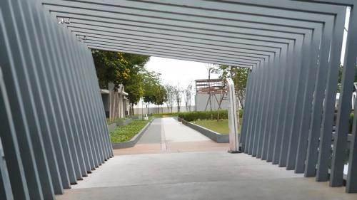 an entrance to a building with a metal archway at BSP21 Family Homestay in Jenjarum