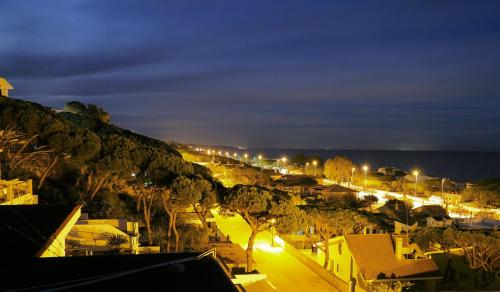 a view of a city at night with lights at La Casa de Oti playa Mazagón vistas al mar in Mazagón