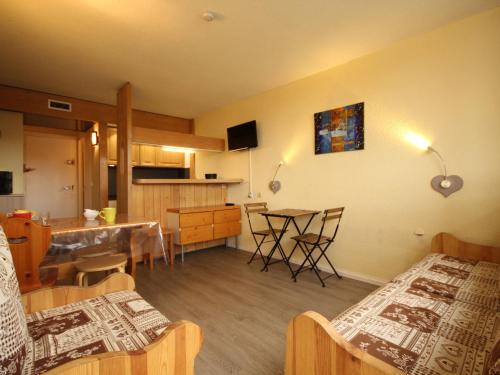 une chambre avec deux lits et une cuisine avec une table dans l'établissement Appartement cosy 5 pers · Ski aux pieds · Balcon · Wifi - FR-1-346-419, à Arc 1800