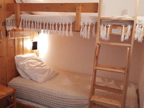 a bedroom with a bunk bed and a ladder at Studio Les Arcs 1800, 1 pièce, 5 personnes - FR-1-346-422 in Arc 1800