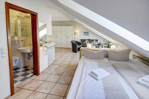 a living room with a bed and a sink at fewo1846 Strandresidenz Wassersleben - Kleine Meerjungfrau - komfortables Studioapartment im Dachgeschoss in Harrislee