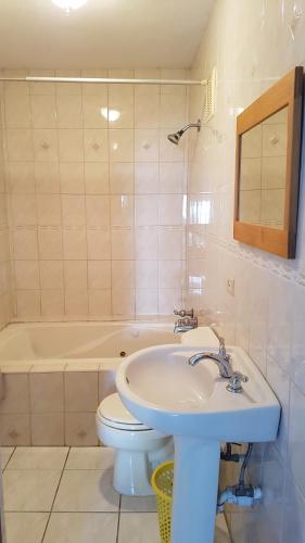 a bathroom with a sink and a toilet and a tub at AIRBAB Moon Gate East in Mount Pleasant