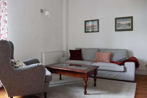 a living room with a couch and a coffee table at Gutshaus Alt Vorwerk in Boddin
